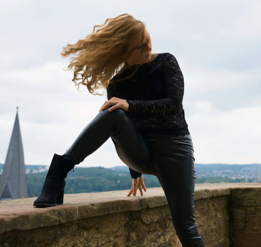 High-fashion portrait with sculptural hair and effortless poise at Marburg Castle