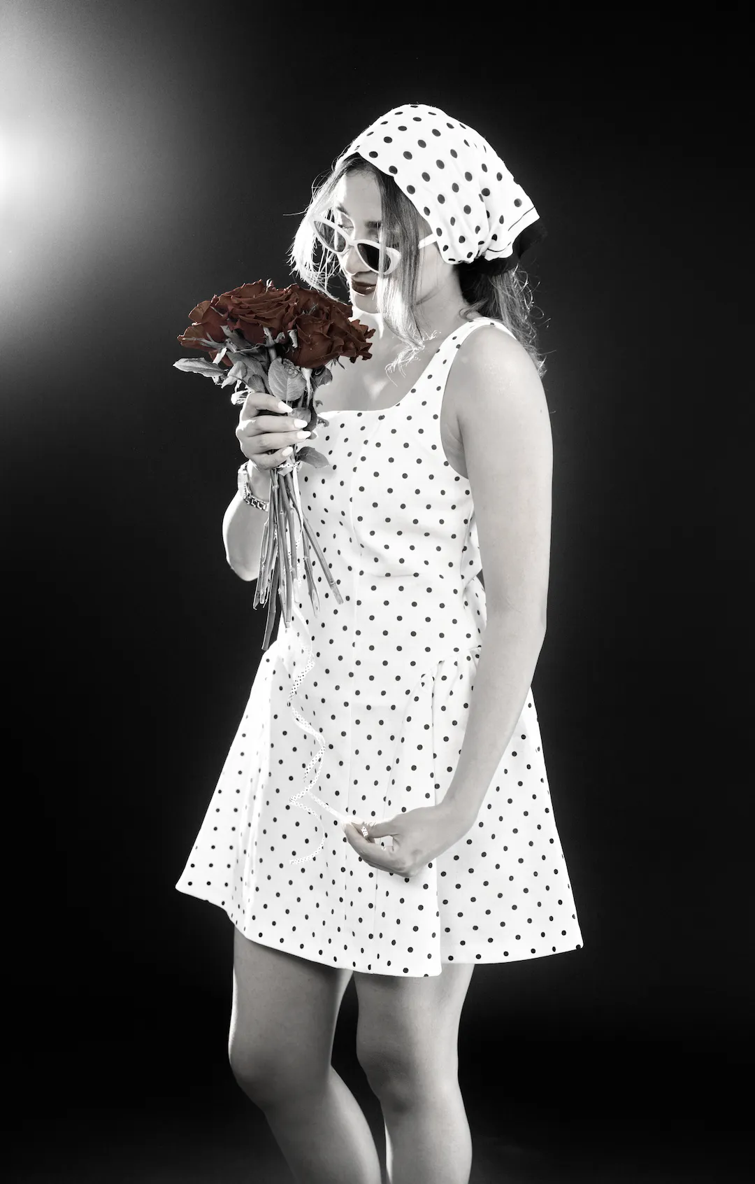 Studio portrait photography with off-camera flash dreamy pose while sniffing a bouquet of flowers